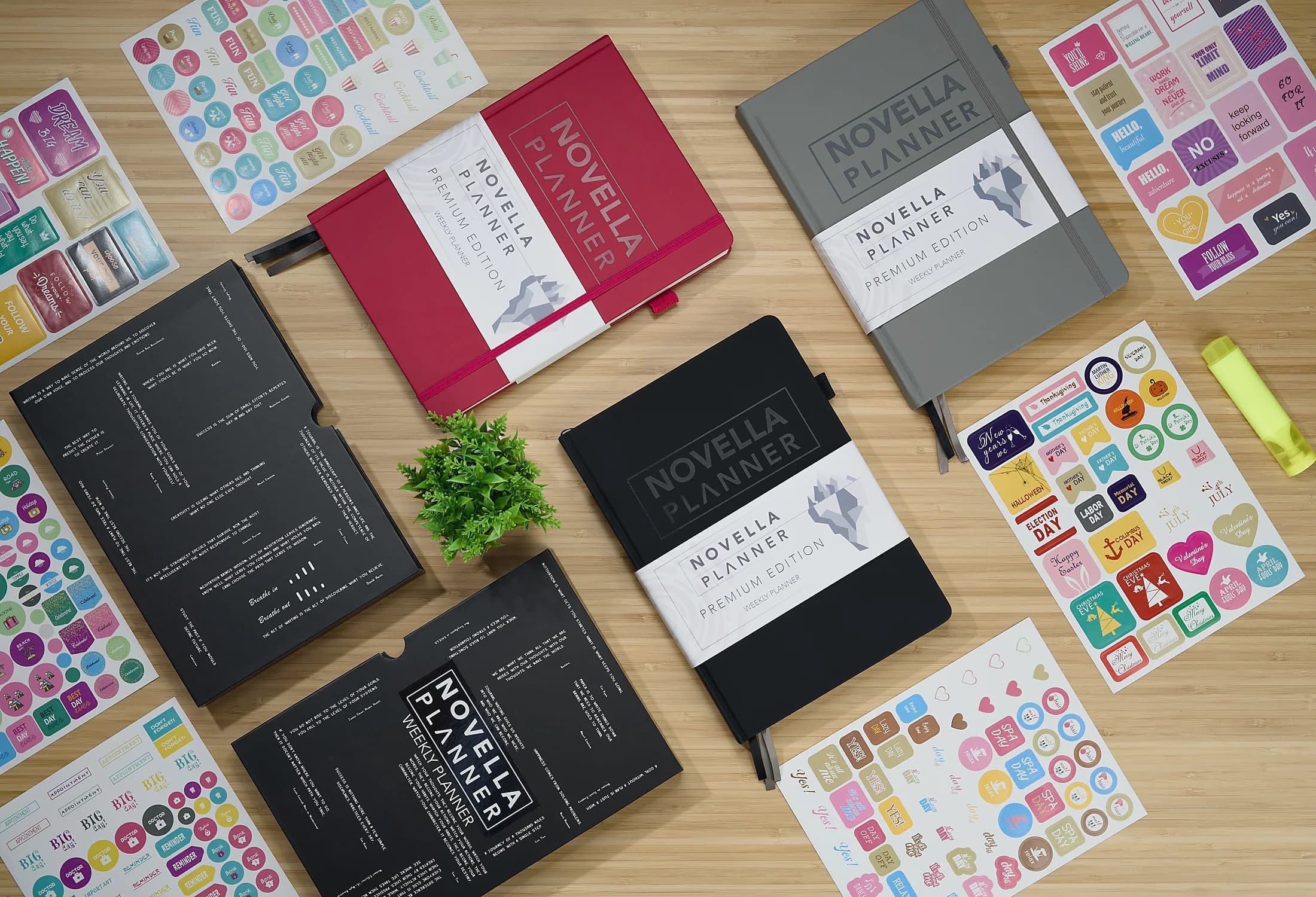 Red, black, and grey Novella Planners arranged with notes and stickers